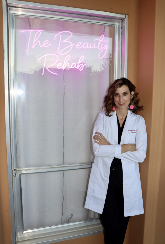 andrea in front of the beauty rehab neon sign