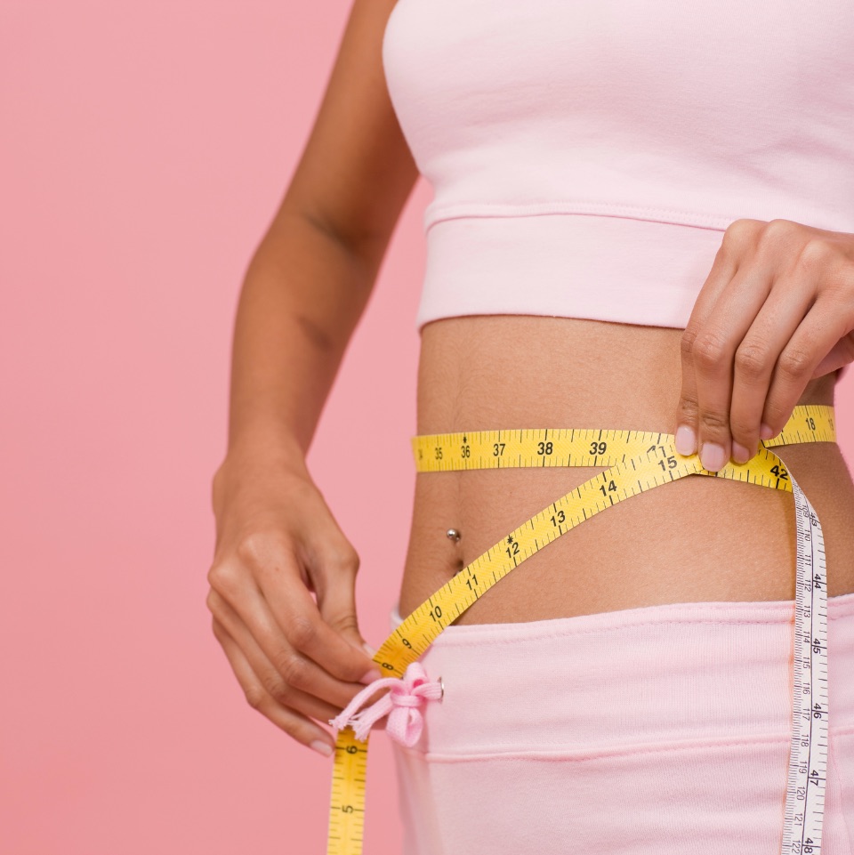 woman measuring waist with measuring tape after semaglutide treatment