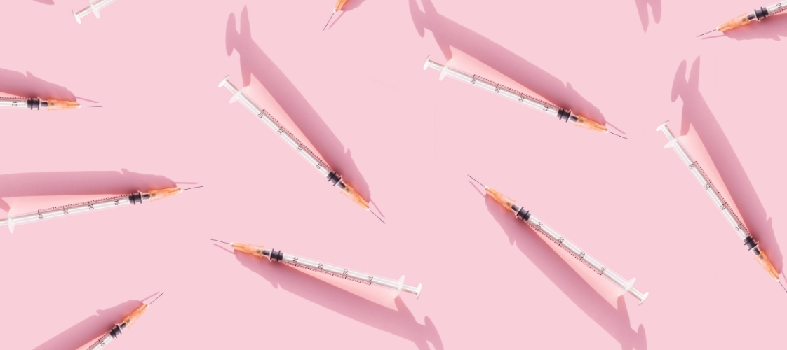 syringes against pink background